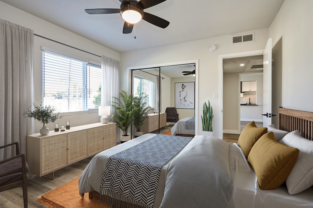 Large bedroom with full bed and artistic decor